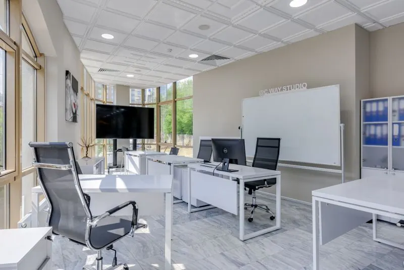 Bright spacious modern office interior with sleek minimalist furniture and large windows